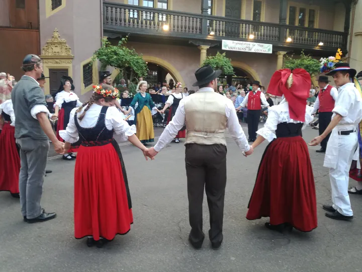 Folklore dancing in the evening at Colmar, Alsace (France)